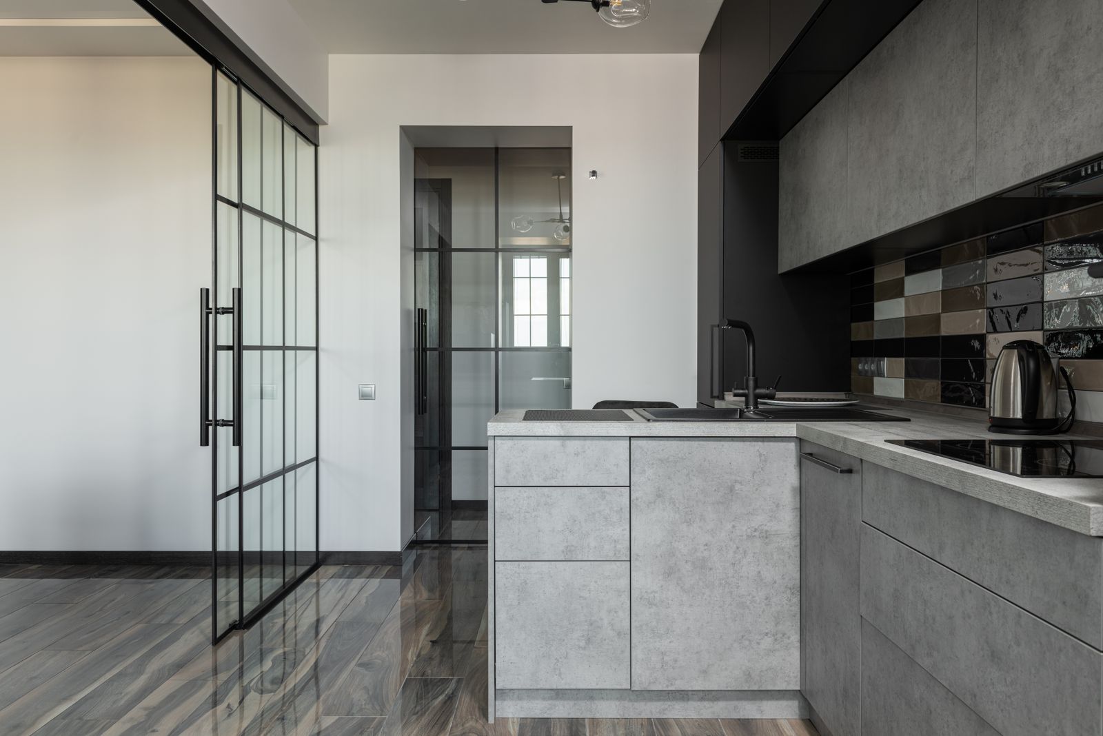 Finished grey kitchen with glazed partition